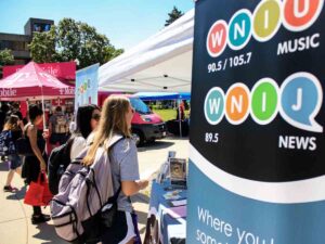 Students and Community members visit with WNIJ at the annual Campus Meets Community event at NIU